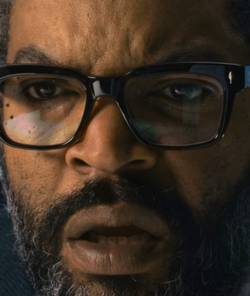 Ice Cube squinting at a monitor in War of the Worlds (2025)